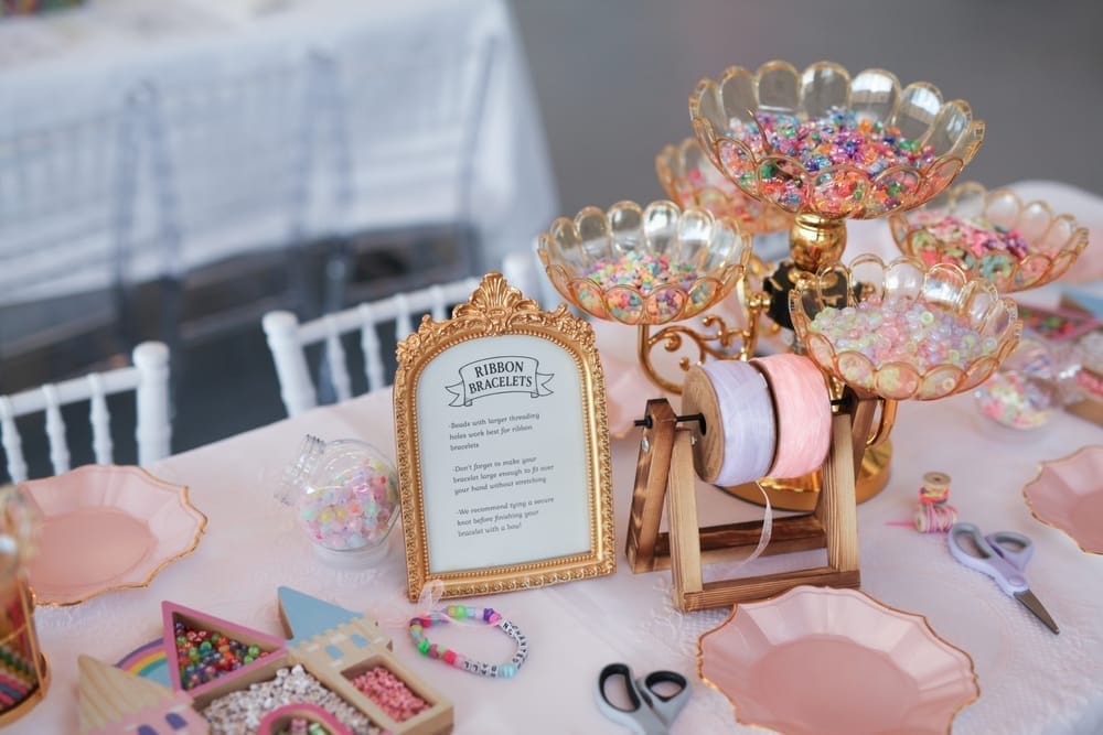 Enchanted Ball ribbon bracelet station with pastel beads and crafting supplies